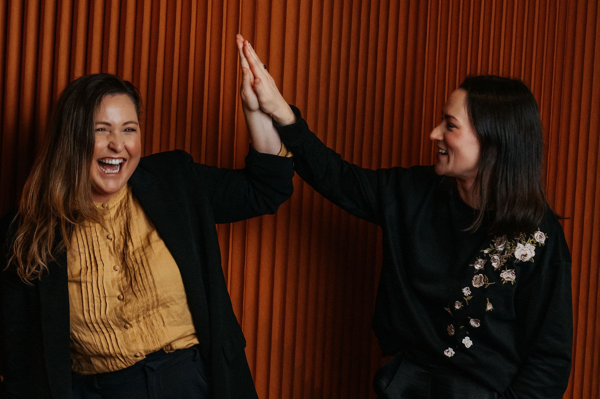 Two Fractional Directory team members high-fiving